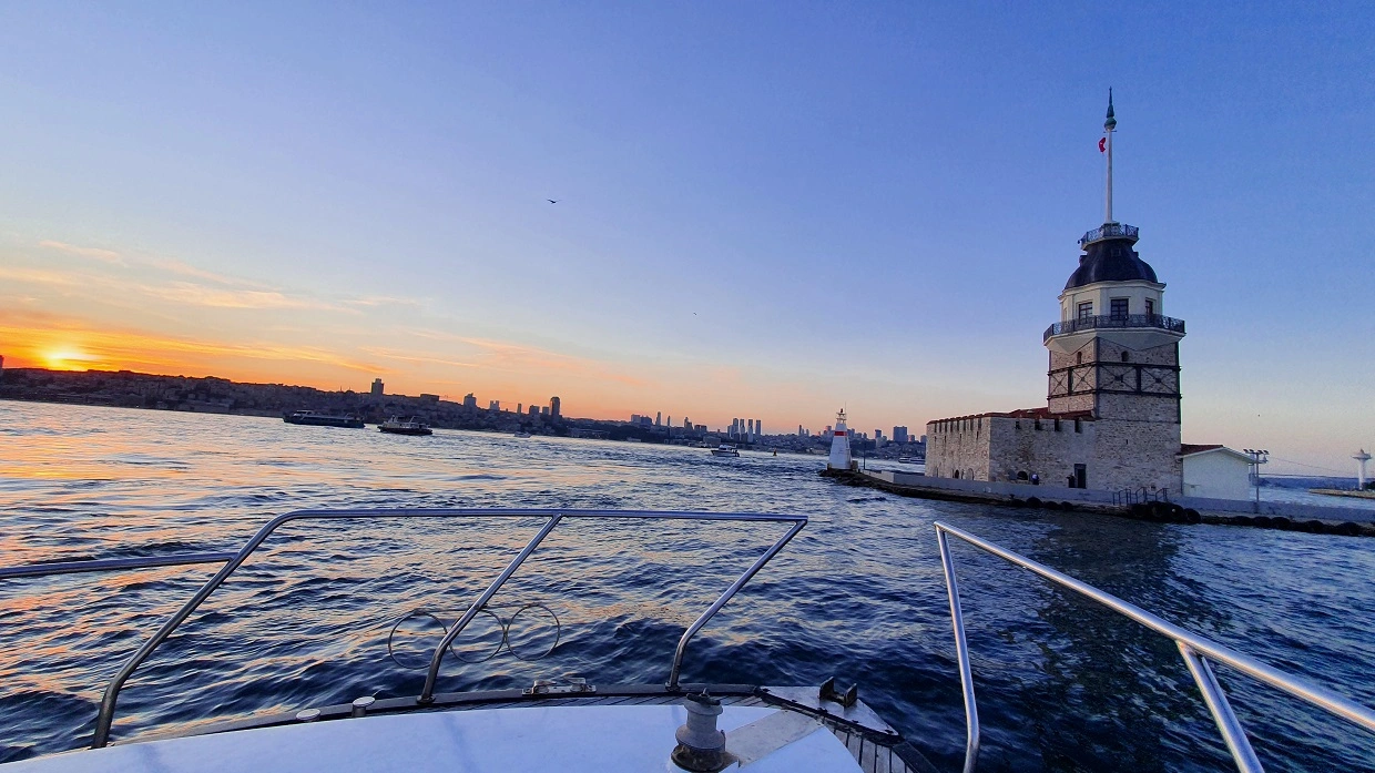 The sunset against the Maiden's Tower from a luxury yacht in the Bosphorus